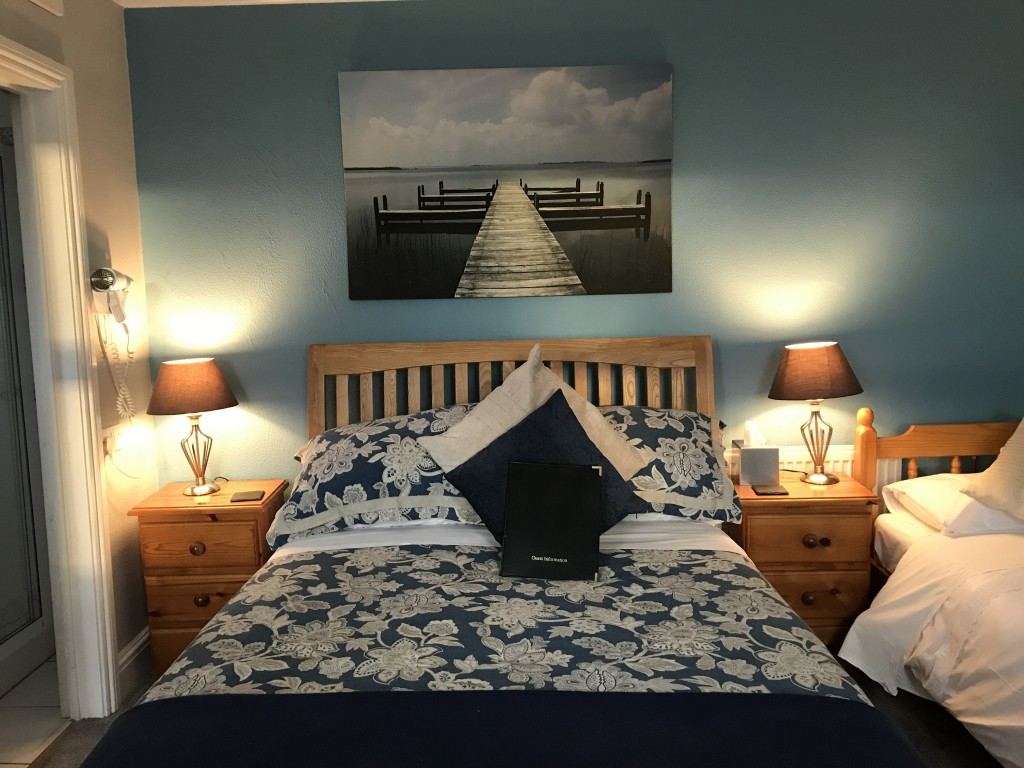 Double bedroom with blue walls and wooden furniture