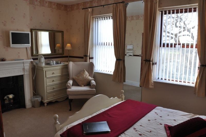 Double bedroom with fireplace and armchair
